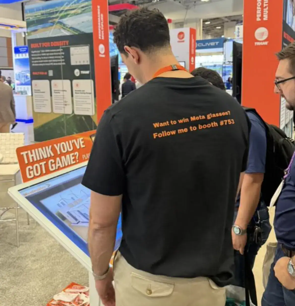 people playing the trade show game while Weidmuller team member looks on