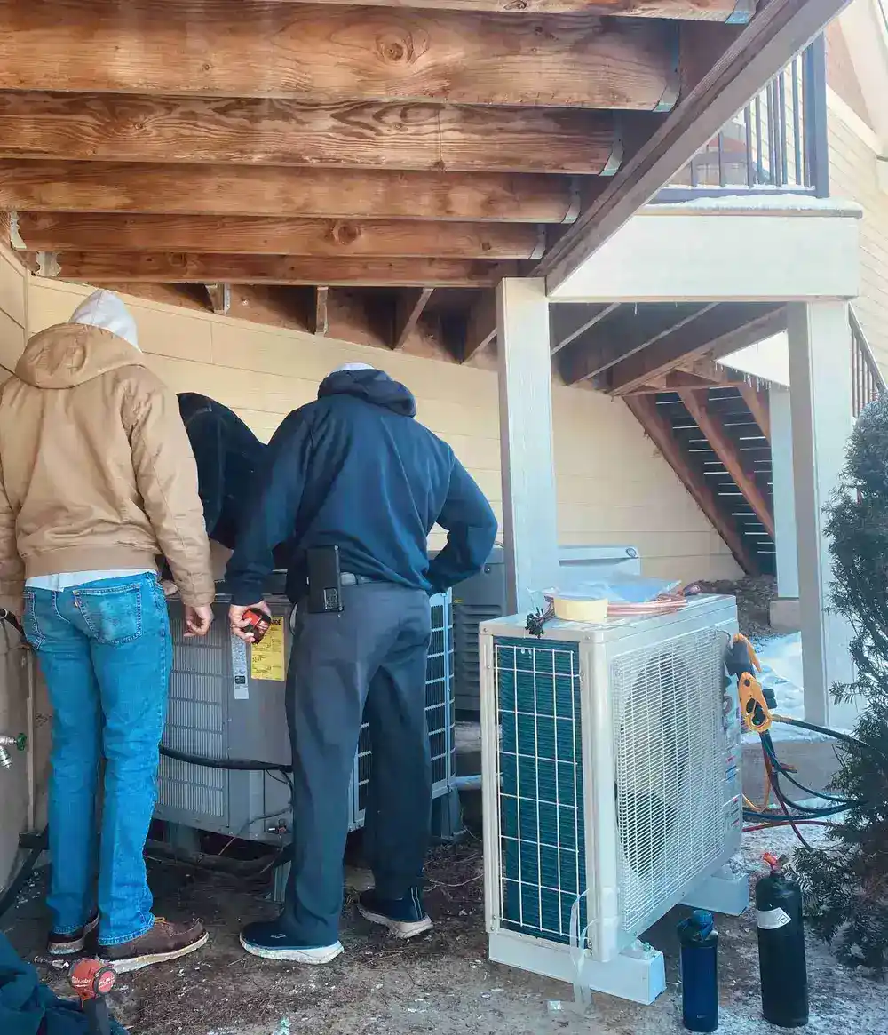 Technicians working on HVAC unit