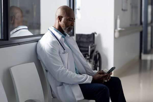 woman waiting at the doctors office with tablet