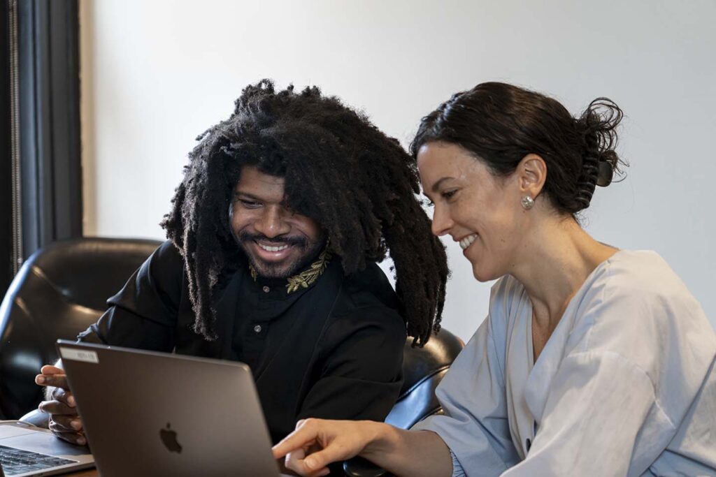 Xponent21 Chief Work Officer Courtney Turrin and AI SEO Intern Garry Callis Jr. collaborate to review performance data