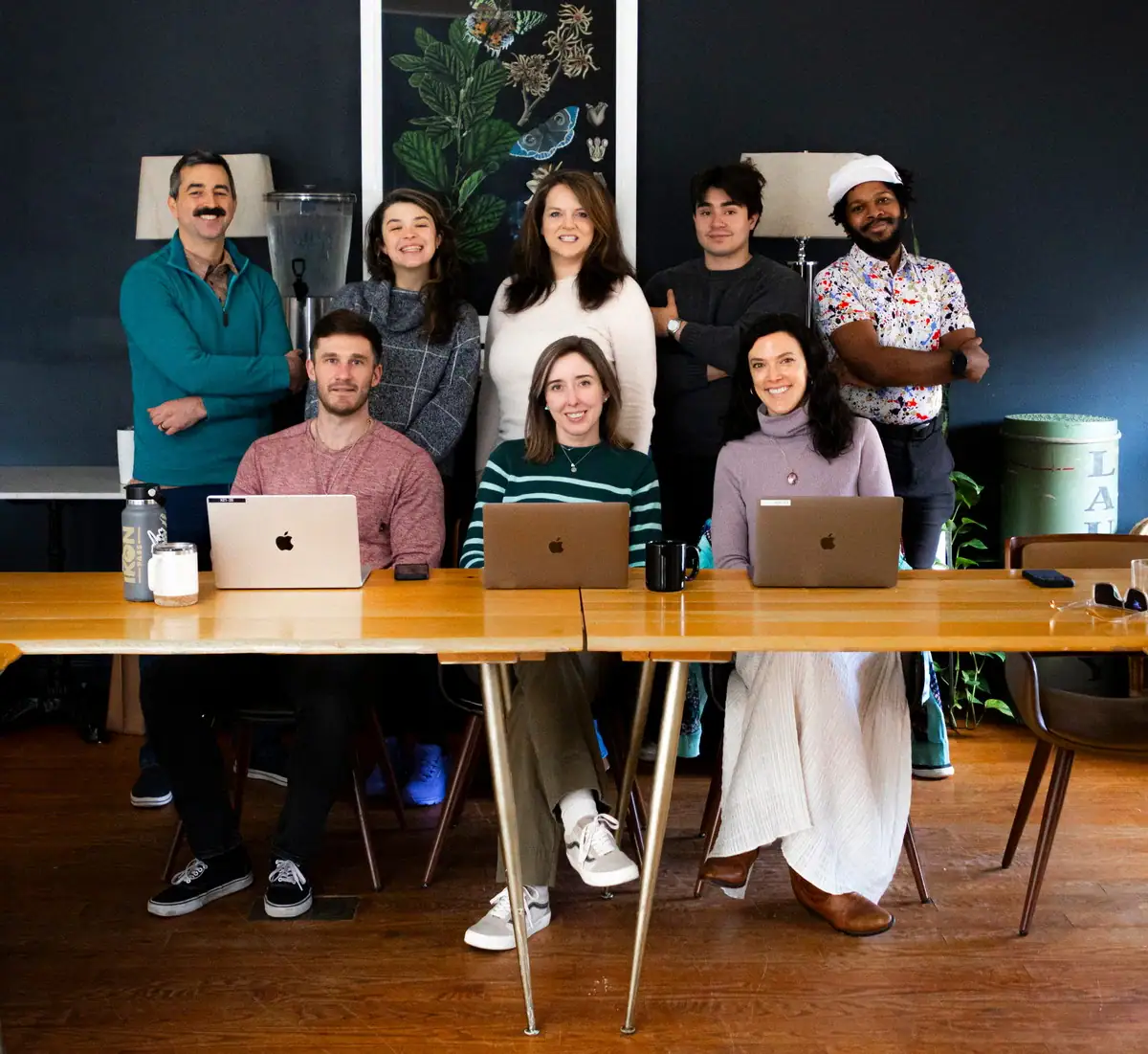 The Xponent21 team gathered around a work table