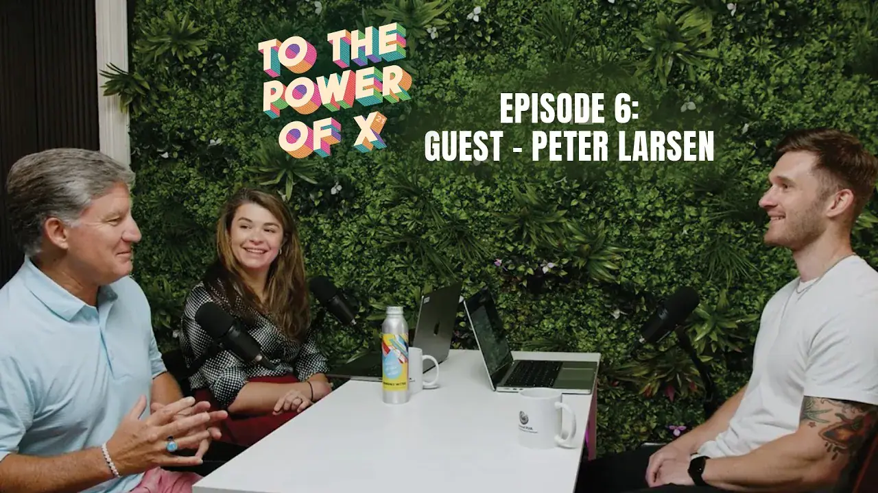 Three people sitting around a table recording podcast To the Power of X